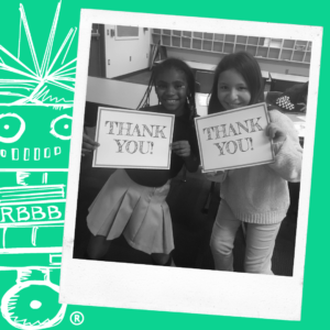 a polaroid image of two students holding signs that say thank you. the background is green with a white outline of dr. dave